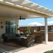 Outdoor living room under a solid patio cover